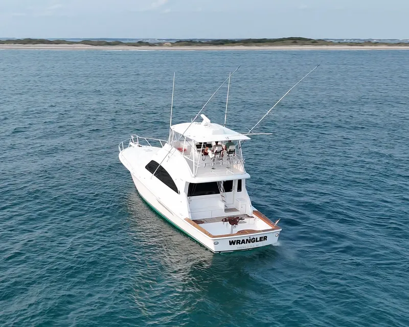 Slide: The Image of 2008 Ocean Yachts 54 Super Sport cruising on open water, near a distant shoreline. - 2