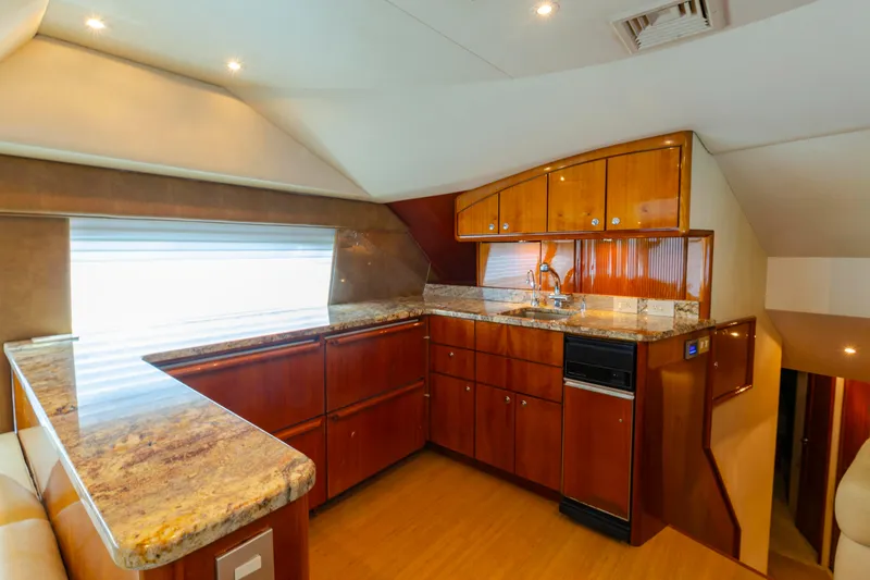 Slide: The Image of Luxurious kitchen interior of 2008 Ocean Yachts 54 Super Sport with wood cabinetry and granite countertops. - 22