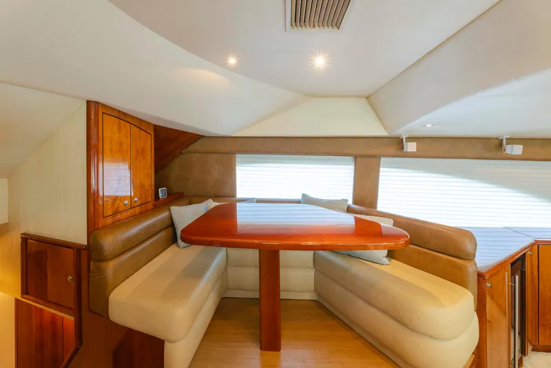 Slide: The Image of Luxurious dining area in 2008 Ocean Yachts 54 Super Sport, featuring elegant wood finishes. - 23