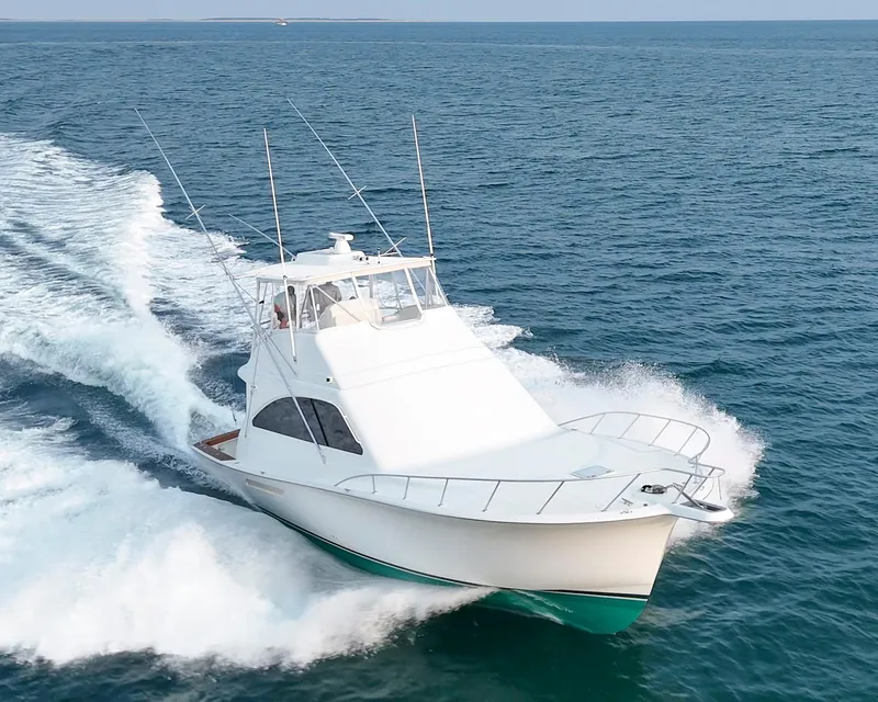 Slide: The Image of 2008 Ocean Yachts 54 Super Sport cruising on open sea, creating waves. - 3