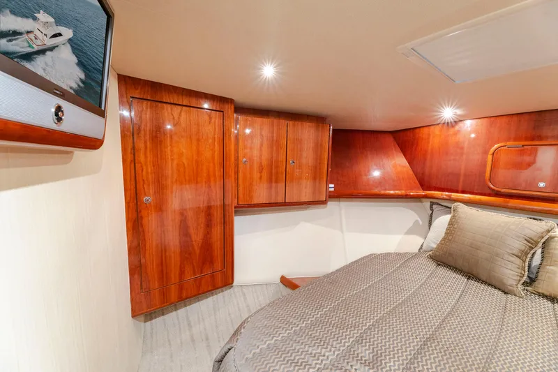 Slide: The Image of Luxurious cabin interior of 2008 Ocean Yachts 54 Super Sport with wood paneling and cozy bedding. - 32