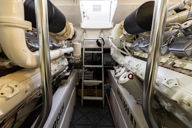 Slide: The Image of Engine room of 2008 Ocean Yachts 54 Super Sport, featuring dual engines and ladder access. - 39