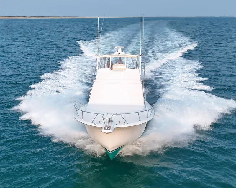 Slide: The Image of 2008 Ocean Yachts 54 Super Sport cruising on open water, creating a dynamic wake. - 5