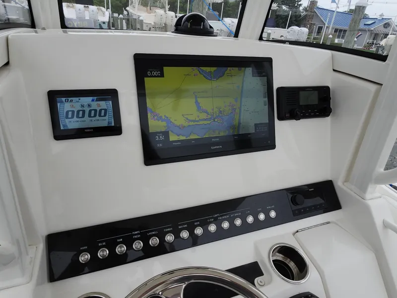 Slide: The Image of 2021 Regulator 25 boat dashboard with Garmin navigation and Yamaha display. - 11