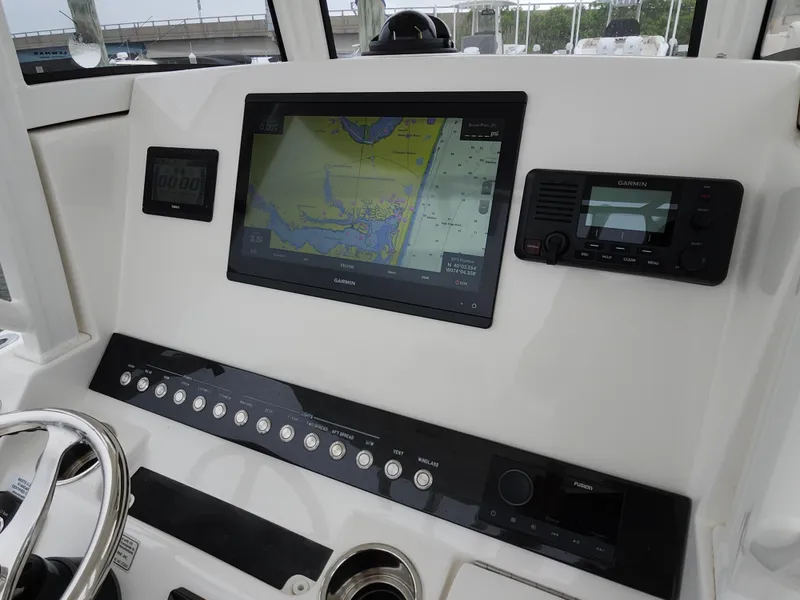Slide: The Image of 2021 Regulator 25 boat dashboard with Garmin navigation and control panel. - 12