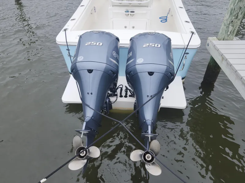 Slide: The Image of Twin Yamaha 250 outboard engines on a 2021 Regulator 25 boat at dock. - 22