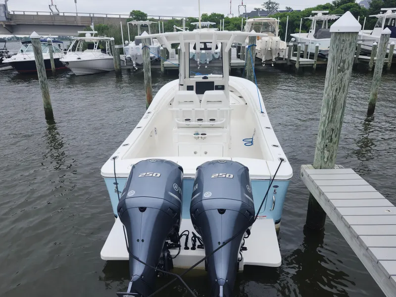 Slide: The Image of 2021 Regulator 25 boat docked with twin 250 horsepower engines. - 4