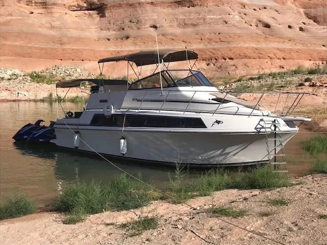 The Image of 1986 Carver Mariner 32x14.3 boat docked in a scenic canyon waterway. - 0