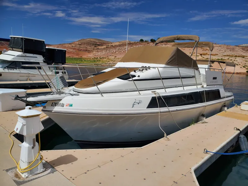 Slide: The Image of 1986 Carver Mariner 32x14.3 boat docked at marina under clear blue sky. - 20