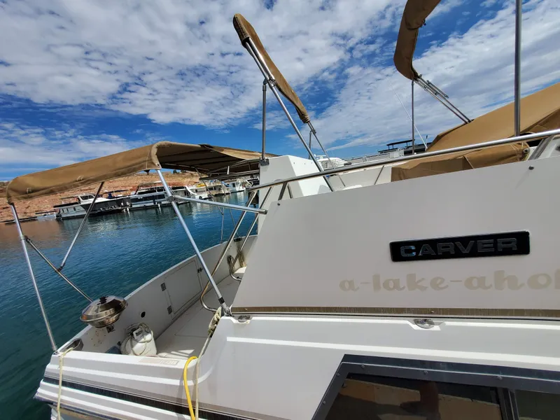 Slide: The Image of 1986 Carver Mariner 32x14.3 boat docked at marina under blue sky. - 24