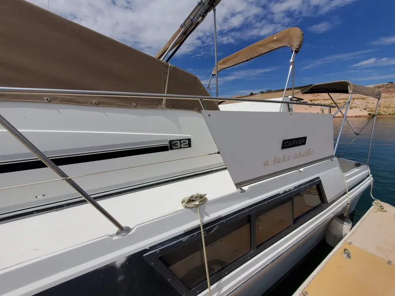 Slide: The Image of 1986 Carver Mariner 32x14.3 boat docked, featuring sleek design and clear blue sky backdrop. - 25
