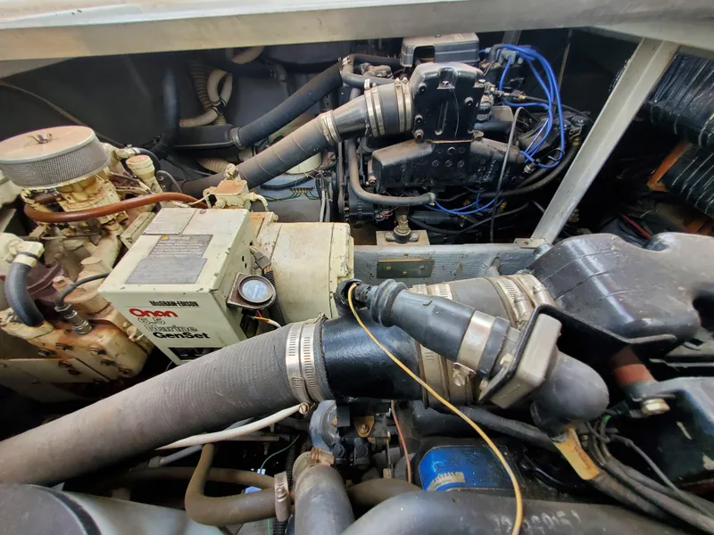 Slide: The Image of Engine compartment of a 1986 Carver Mariner 32x14.3 boat, showcasing mechanical components. - 33