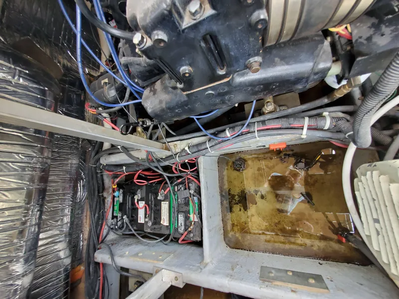 Slide: The Image of Engine compartment of a 1986 Carver Mariner 32x14.3 with visible wiring and components. - 36