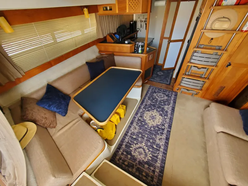 Slide: The Image of Interior of 1986 Carver Mariner 32x14.3 yacht with cozy seating and nautical decor. - 37