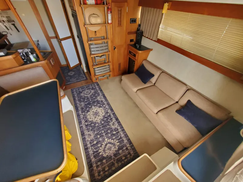Slide: The Image of Interior of 1986 Carver Mariner 32x14.3 yacht with cozy seating and nautical decor. - 38
