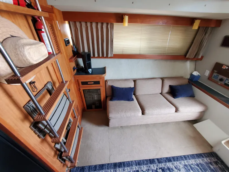 Slide: The Image of Interior of 1986 Carver Mariner 32x14.3 yacht with sofa, ladder, and striped curtains. - 39
