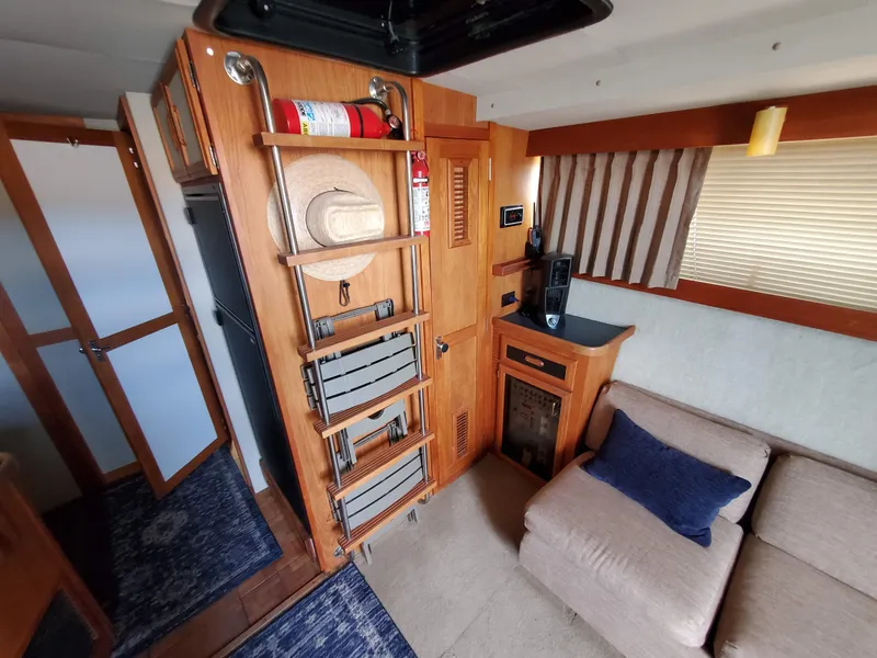 Slide: The Image of Interior of 1986 Carver Mariner 32x14.3 boat with cozy seating and wooden cabinetry. - 40