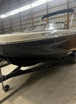 Slide: The Image of 2021 Bayliner DX 2250 boat on trailer in indoor storage facility. - 12