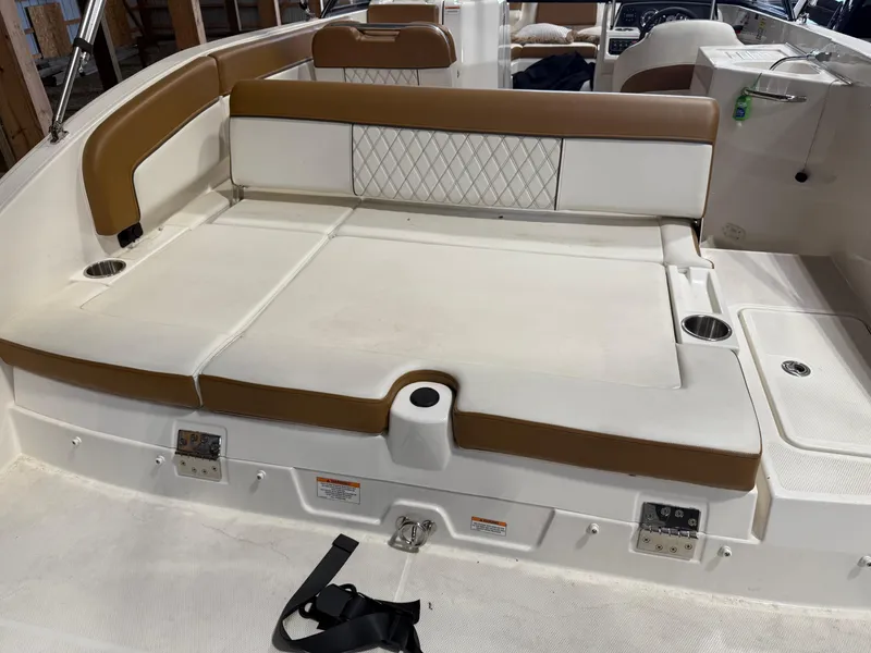Slide: The Image of 2021 Bayliner DX 2250 boat interior with cushioned seating and cup holders. - 5
