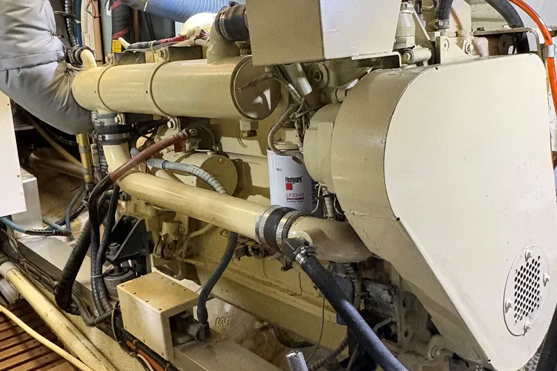 Slide: The Image of Engine room of a 1990 Grand Banks Classic boat, showcasing mechanical components. - 19