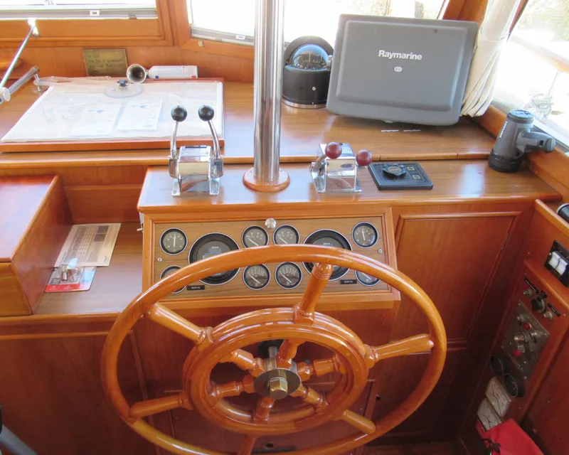 Slide: The Image of 1990 Grand Banks Classic helm with wooden wheel and navigation equipment. - 7