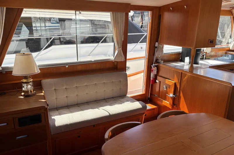 Slide: The Image of Interior of 1990 Grand Banks Classic yacht with wooden furnishings and cozy seating area. - 10