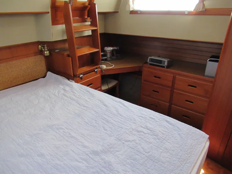 Slide: The Image of Cozy cabin interior of 1990 Grand Banks Classic yacht with wooden furniture and bed. - 13