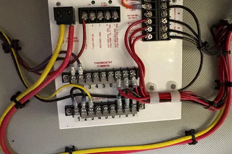 Slide: The Image of Electrical wiring panel on a 1990 Grand Banks Classic boat, featuring labeled connections. - 22
