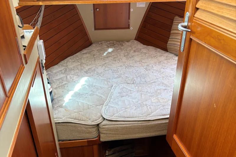 Slide: The Image of Cozy cabin interior of 1990 Grand Banks Classic boat with a comfortable bed. - 16