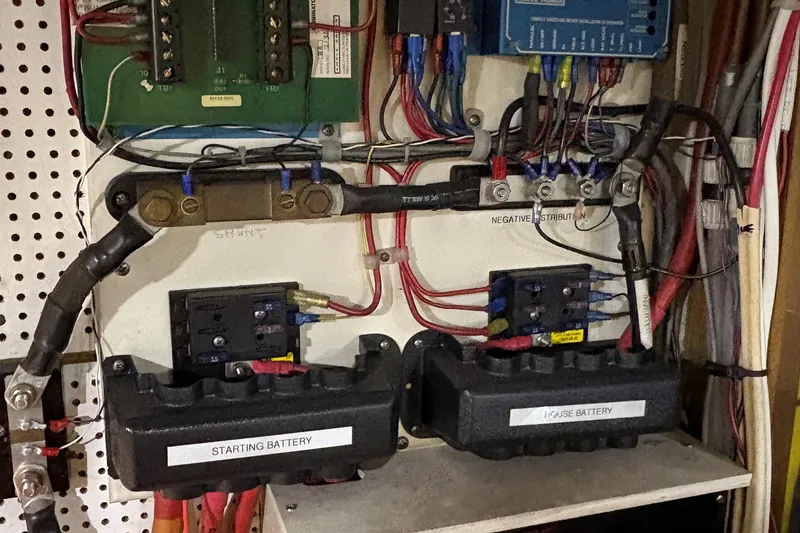 Slide: The Image of Electrical panel of a 1990 Grand Banks Classic boat with labeled batteries and wiring. - 21