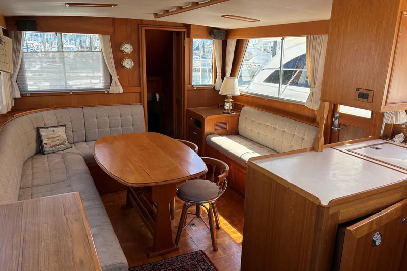 Slide: The Image of Interior of 1990 Grand Banks Classic yacht with wooden furnishings and cozy seating area. - 6