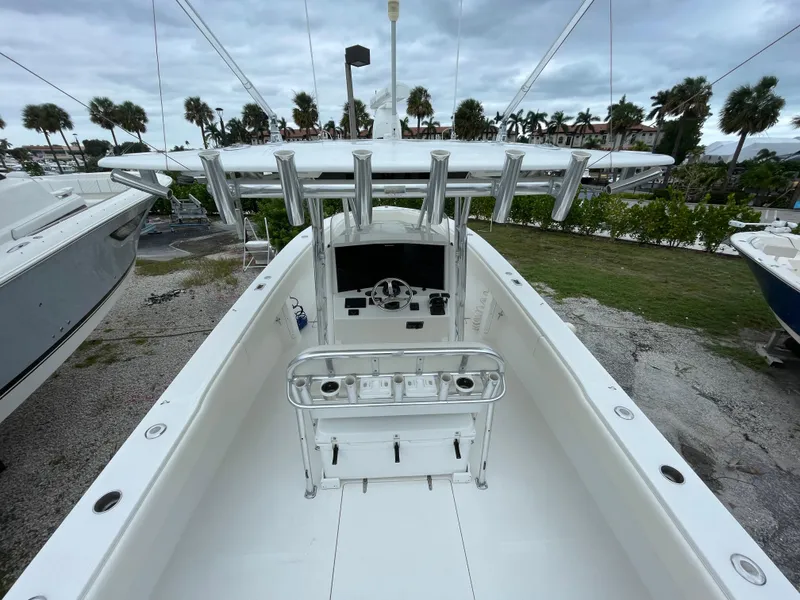 Slide: The Image of 2000 Venture 34 Tournament boat, center console, docked with palm trees in background. - 10