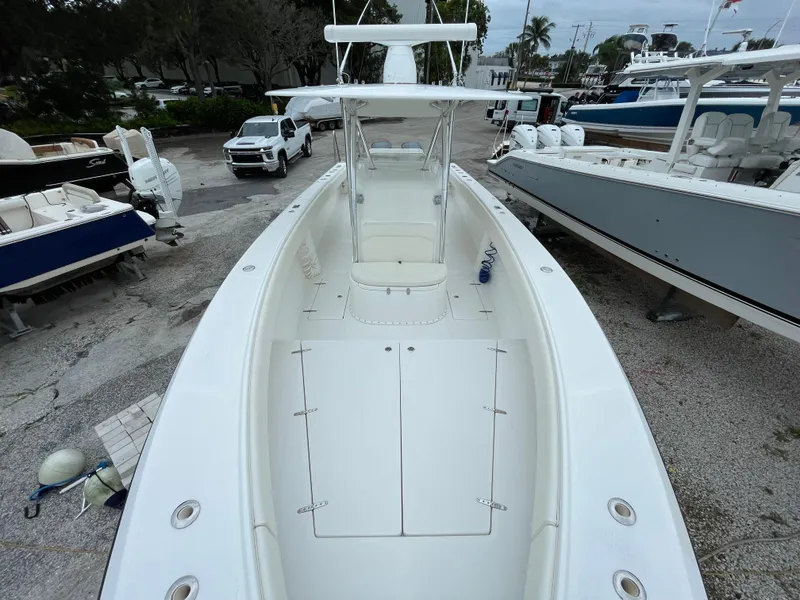 Slide: The Image of 2000 Venture 34 Tournament boat, white deck, parked among other boats. - 11