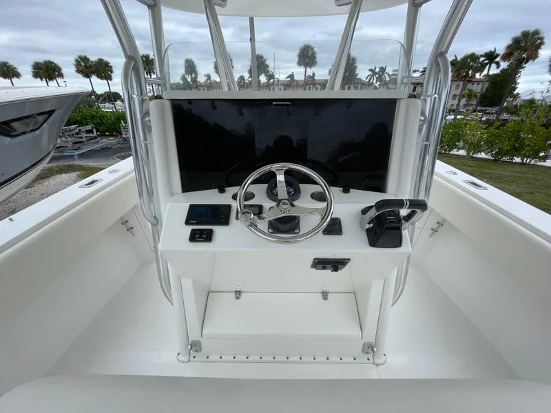Slide: The Image of Venture 34 Tournament 2000 boat helm with steering wheel and controls. - 16
