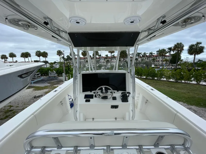 Slide: The Image of Venture 34 Tournament 2000 boat cockpit with steering wheel and controls, surrounded by palm trees. - 17