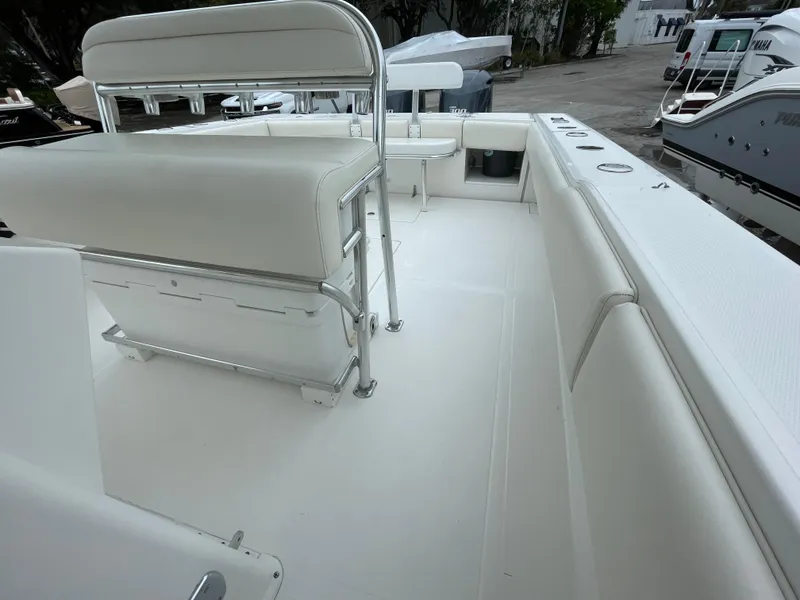 Slide: The Image of 2000 Venture 34 Tournament boat interior with white seating and spacious deck. - 20