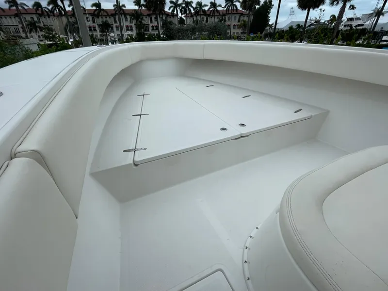 Slide: The Image of Venture 34 Tournament 2000 boat interior with white seating and storage compartments. - 25