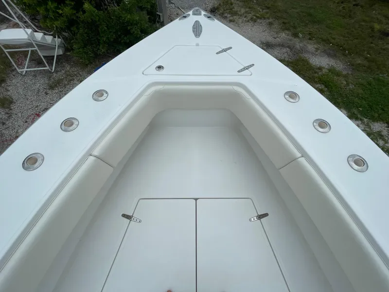 Slide: The Image of Bow of 2000 Venture 34 Tournament boat with seating and storage compartments. - 28