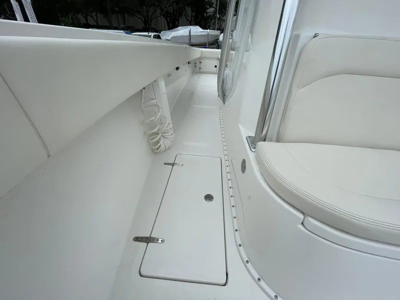 Slide: The Image of Venture 34 Tournament 2000 boat interior with white seating and storage compartment. - 30