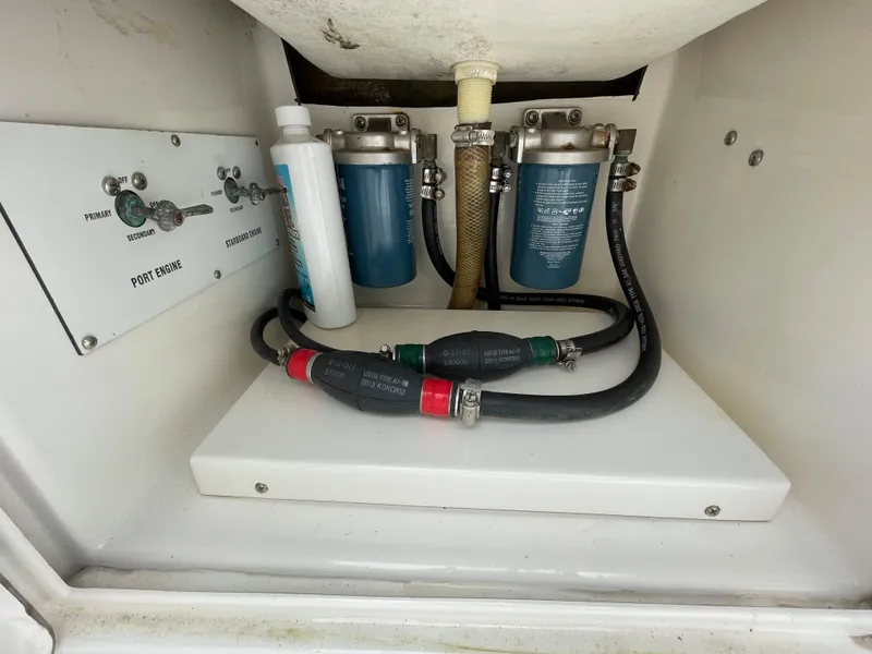 Slide: The Image of Venture 34 Tournament 2000 boat engine compartment with filters and hoses. - 32