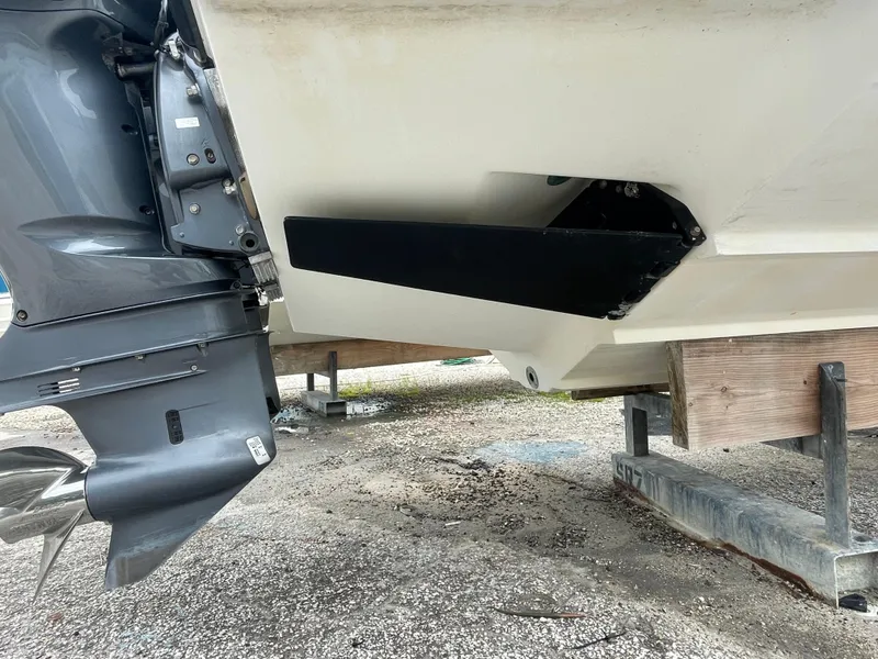 Slide: The Image of 2000 Venture 34 Tournament boat stern with outboard motor on dry dock. - 7