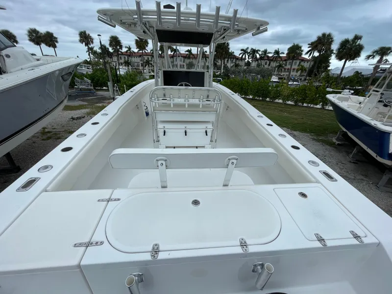 Slide: The Image of 2000 Venture 34 Tournament boat with spacious deck and seating, docked outdoors. - 8