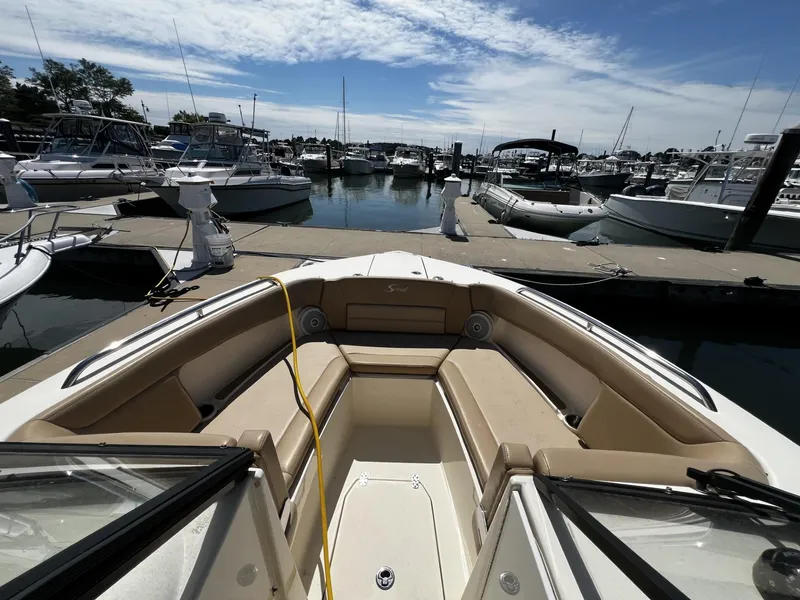 Slide: The Image of 2019 Scout 255 Dorado boat docked at marina under clear sky. - 11