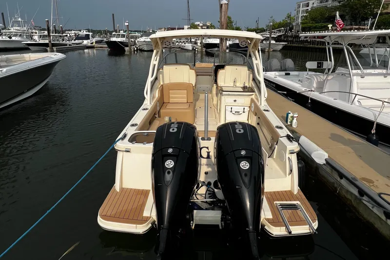 Slide: The Image of 2019 Scout 255 Dorado boat docked with twin outboard engines. - 2