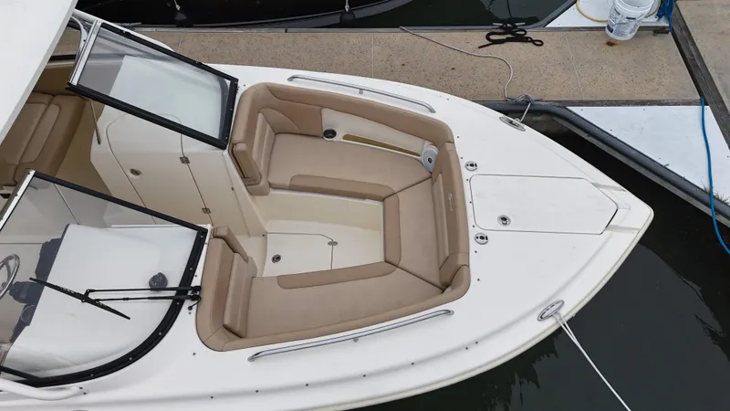 Slide: The Image of 2019 Scout 255 Dorado boat with beige seating, docked at marina. - 6