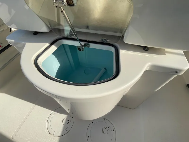 Slide: The Image of 2013 Pursuit C 260 Center Console livewell with open lid, showcasing interior. - 14