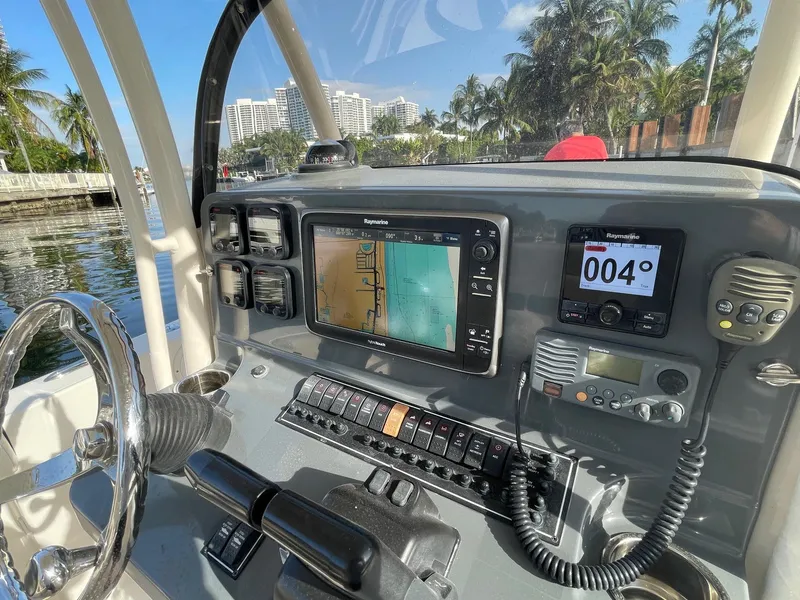 Slide: The Image of 2013 Pursuit C 260 Center Console dashboard with navigation equipment and controls. - 17