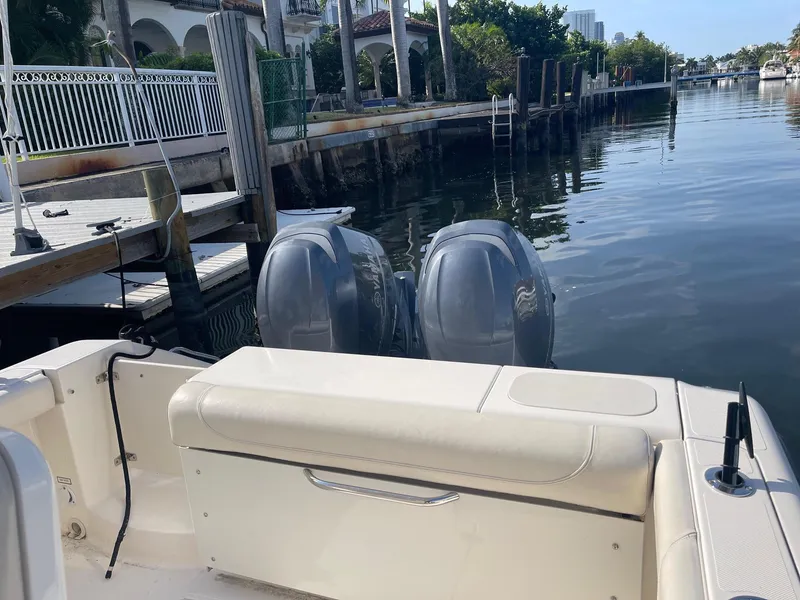 Slide: The Image of 2013 Pursuit C 260 Center Console boat docked with dual outboard engines. - 19