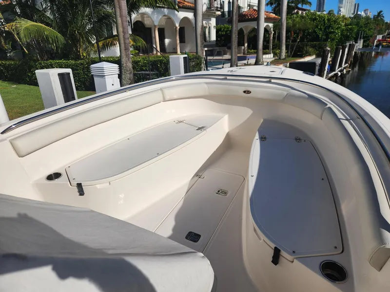 Slide: The Image of 2013 Pursuit C 260 Center Console boat interior with seating and storage compartments. - 2