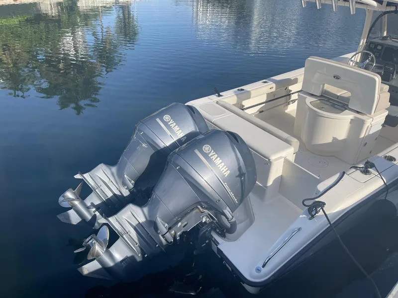 Slide: The Image of 2013 Pursuit C 260 Center Console boat with twin Yamaha outboard engines on calm water. - 5